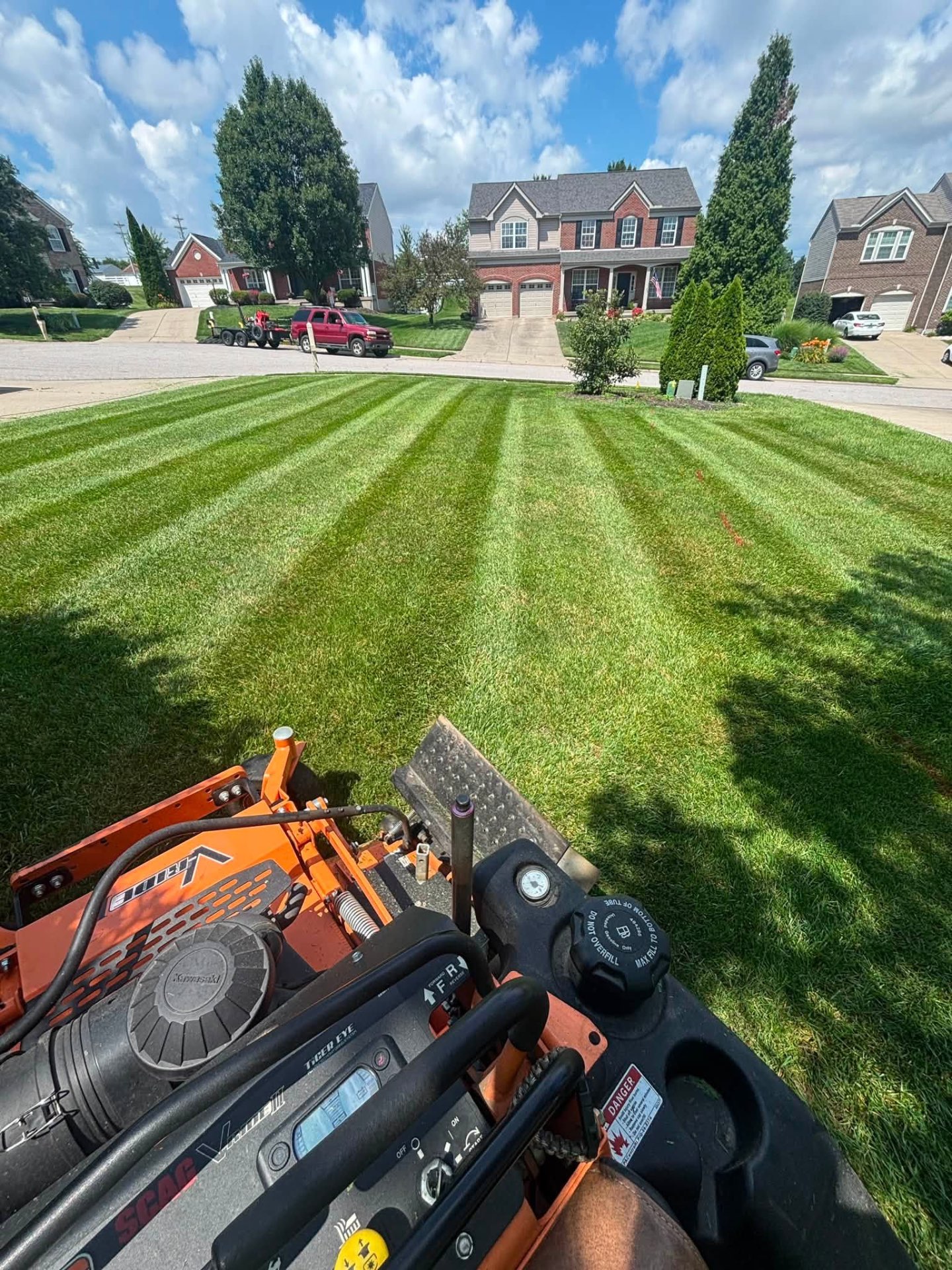 View from a Scag zero-turn mower over a freshly striped front lawn